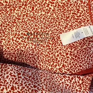 Athleta Salutation Stash ll textured tight, orange and white, size small